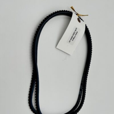 An Atlas Copco V-Belt Set (P/N 2203 0999 19) with a notched black rubber belt rests on a white surface, featuring an attached white tag with text and a gold twist tie.