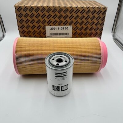 Two cylindrical filters—a large tan filter with pink ends and a smaller white metal filter—are shown in front of a patterned box labeled "Atlas Copco Air/Oil Filter Kit (P/N 2901 1105 00).
