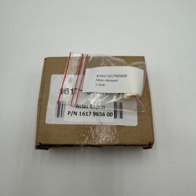 A small brown cardboard box with a white label reading "Atlas Copco Filter Element (P/N 1617965600)" and a plastic bag containing the filter element, placed on a white surface.