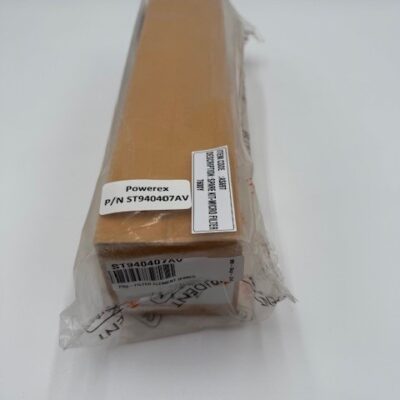 A rectangular brown box, partially wrapped in clear plastic and labeled “Powerex, Inc. Pre-Filter Element (P/N ST940407AV),” sits on a plain white surface.