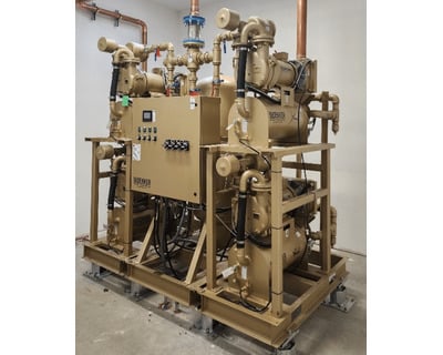Industrial Bekker vacuum pump system mounted on a metal frame with copper piping and a central electrical control panel.