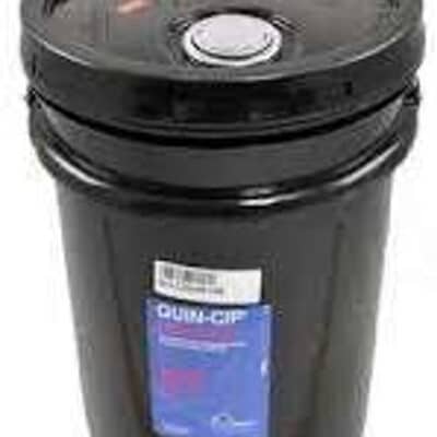 A large black industrial plastic bucket with a tightly sealed lid and a blue label, containing Quincy Compressor Quin-Cip Oil ISO-100 5 Gallon (P/N 112543P100).