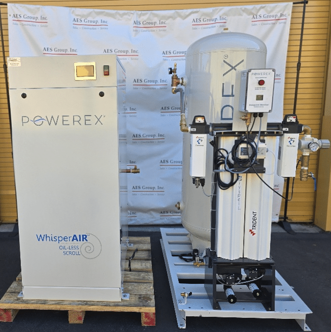A Powerex Inc. Laboratory Compressed Air System (P/N SEQ2007HP-AES-SPL) is displayed on pallets before an AES Group Inc. banner, set against a yellow wall.