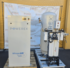 Two large industrial "Powerex Inc. Laboratory Compressed Air System (P/N SEQ2007HP-AES-SPL-DD)" units are displayed outside on pallets with a cylindrical tank, control panel, and an AAFS Group, Inc. banner in the background.