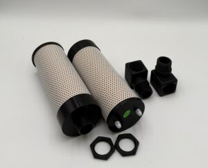 Two Trident Muffler Kits for Trident Dryspell Plus 45/60 (P/N SK328A), each including a cylindrical filter with black ends, black connector fittings, and hexagonal nuts, are arranged on a plain white surface. The filters feature a white perforated exterior with a dotted pattern.