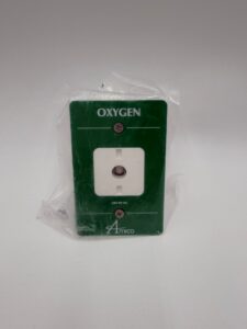 A green and white Amico Outlet, Ohmeda Extended Front for oxygen (P/N O-FASE-QD-U-OXY), featuring a central outlet covered in clear plastic and labeled “OXYGEN,” with the Amico logo displayed at the bottom.