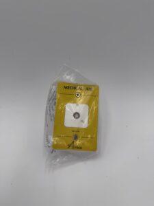 An Amico Outlet, Ohmeda Extended Front, Medical Air (P/N O-FASE-QD-U-AIR) faceplate in yellow, partially wrapped in clear plastic, is displayed against a plain white background.